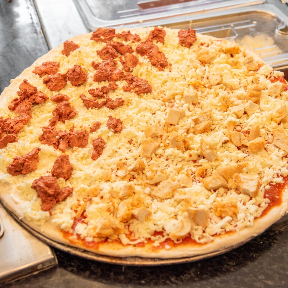 Specialty pizza topped and ready for the oven.